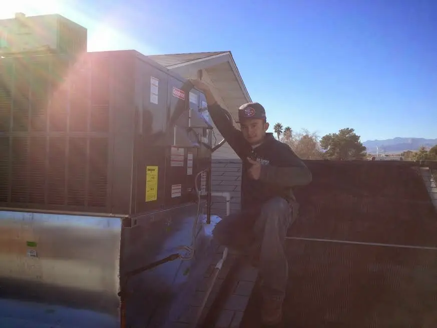 HVAC technician performing AC Tune-Up on a rooftop unit in Pequea